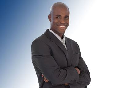 black man with arms crossed smiling
